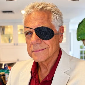 May include: A black textured leather eye patch with a thin strap. The image features the text Custom Leather Eye Patches and ANY COLOR AND CUSTOM LASER ENGRAVED at the top. The patch is worn over one eye, showing a detailed grain pattern.