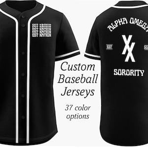 May include: Black baseball jersey with white trim and text. The front of the jersey has the text "EST NATION" repeated four times. The back of the jersey has the text "ALPHA OMEGA SORORITY" with a white "X" logo and the text "EST 2024".