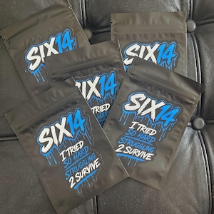 May include: Four black resealable pouches featuring a blue and white graphic logo that reads SIX14. Below the logo, the text reads I TRIED SO HARD STRUGGLING 2 SURVIVE in white and blue lettering with a dripping paint effect on the blue elements.