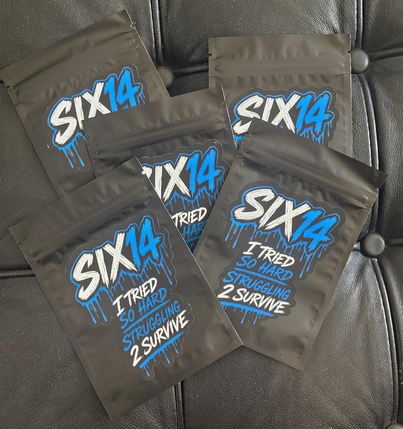 May include: Four black resealable pouches featuring a blue and white graphic logo that reads SIX14. Below the logo, the text reads I TRIED SO HARD STRUGGLING 2 SURVIVE in white and blue lettering with a dripping paint effect on the blue elements.