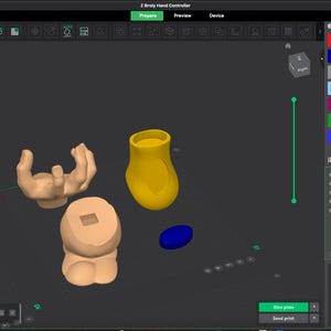May include: A computer screen showing 3D modelling software. The interface displays 3D-rendered objects, including a hand, a cylindrical shape, and a rounded base. The interface shows colour options and settings for 3D printing.