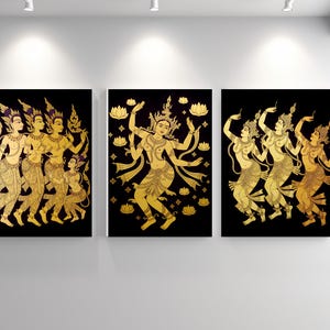 May include: Three framed art pieces featuring gold-colored figures on a black background. The artwork depicts traditional dancers in various poses, with intricate details in their clothing and accessories. The overall theme is cultural and artistic.