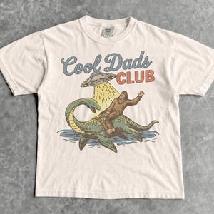 Cool Dads Club T-Shirt - Men & Women's Unisex Graphic Tee - Vintage Bigfoot Dad Shirt - Cryptid UFO - Husband To Be Gifts - Dad To Be Shirt