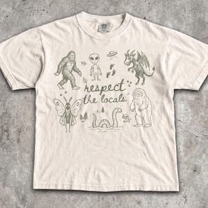 Respect The Locals T-Shirt - Vintage Men & Women's Unisex Graphic Tee - Cryptids - Bigfoot - Mothman - Aliens - Yeti - Folk Horror Shirt Ivory