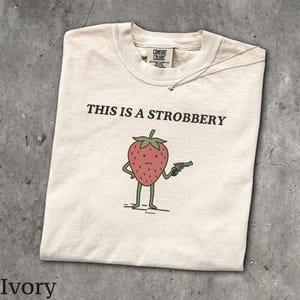 This Is A Strobbery T-Shirt - Men & Women's Unisex Graphic Tee - Ironic Food Shirt - Weird Unginged Strawberry Tee - Funny Fruit Meme Top