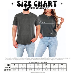 May include: A size chart for Comfort Colors 1717 t-shirts featuring two people wearing charcoal grey shirts. The graphic includes a table with adult unisex sizing in inches, listing width and length measurements for sizes small through 4XL.