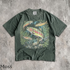 May include: Moss green t-shirt featuring a colorful graphic of several trout swimming amongst aquatic plants and rocks. The fish have vibrant red, yellow, and orange markings. The shirt has a classic crew neck and short sleeves.