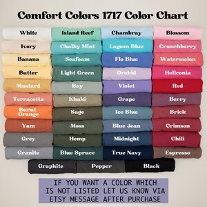 Może przedstawiać: Karta kolor&oacute;w prezentująca r&oacute;żnorodne odcienie Comfort Colors 1717. Karta zawiera kolory takie jak biały, czarny i niebieski, z etykietami tekstowymi dla każdego koloru. Tekst na dole zachęca klient&oacute;w do pytania o kolory niewymienione.