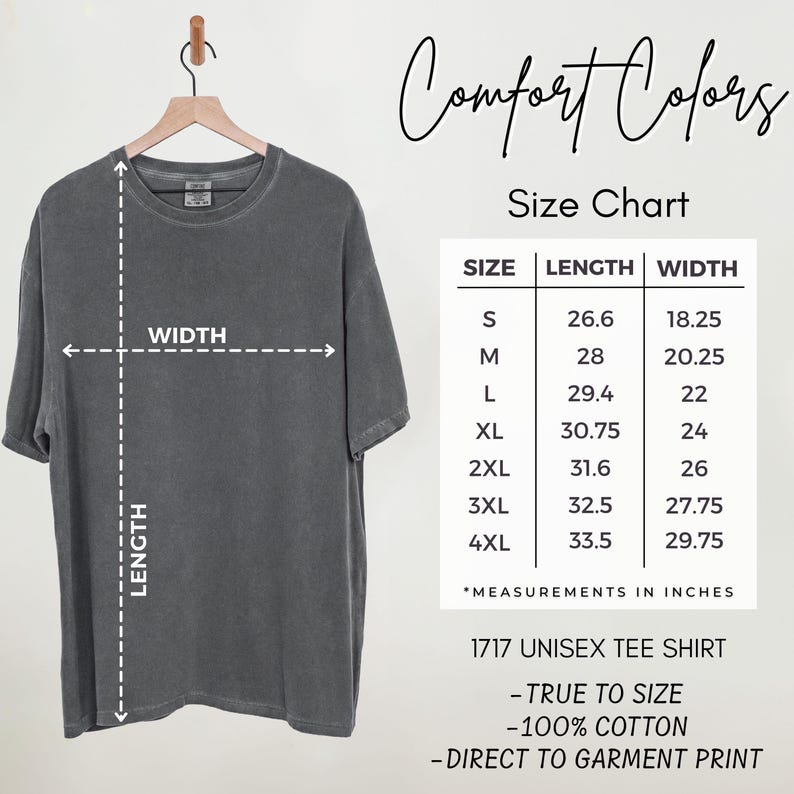 May include: A charcoal grey t-shirt hanging on a wooden hanger next to a size chart. The chart lists sizes S through 4XL with corresponding length and width measurements in inches. Text includes Comfort Colors, Size Chart, and 1717 Unisex Tee Shirt.