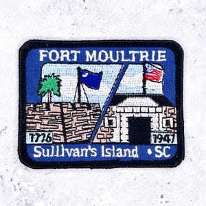 May include: A rectangular embroidered patch with a black border featuring the text FORT MOULTRIE at the top and Sullivan's Island SC at the bottom. The design depicts a stone fort, a palm tree, a blue flag, and a red, white, and blue flag with 1776 and 1947.