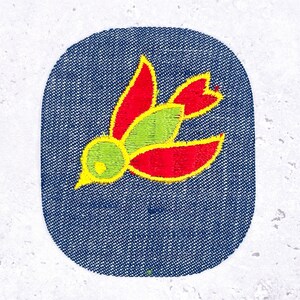 May include: Embroidered patch featuring a stylized bird design. The bird has red wings and tail, a green body, and a yellow beak, all outlined in yellow. The patch is set against a blue denim background with a white border.