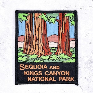 May include: Embroidered patch featuring a scenic view of Sequoia and Kings Canyon National Park. The patch depicts tall redwood trees with brown and orange bark, green foliage, and a blue sky. The text "SEQUOIA AND KINGS CANYON NATIONAL PARK" is displayed in orange.