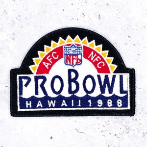 May include: A rectangular patch with a black border and a semi-circular top. The patch features the text "PRO BOWL HAWAII 1988" in white and blue. The top section has "AFC" and "NFC" on a red background, with the NFL logo.