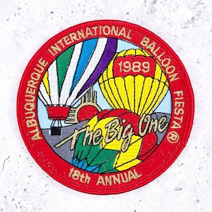 May include: Embroidered patch with a red border featuring hot air balloons in yellow, white, green, and purple. Text includes "Albuquerque International Balloon Fiesta," "The Big One," and "18th Annual," with the year "1989" displayed prominently.