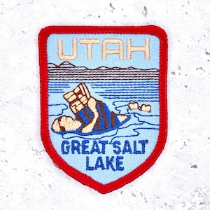 May include: A handmade, wooden cutting board with a natural finish. The board features a live edge on one side and a rectangular shape. It is approximately 18 inches long and 12 inches wide.