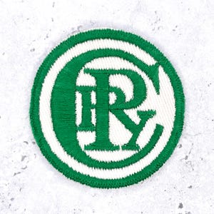May include: A circular embroidered patch featuring a white background with a thick green border. The center displays the intertwined green letters C, I, R, and Y in a serif font, with the letter C forming a large outer frame for the design.