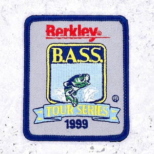 May include: A square patch with a blue border features the text "Berkley" in red above a yellow-bordered rectangle with "B.A.S.S." and a leaping green fish. Below is a banner with "TOUR SERIES 1999" in yellow and blue.