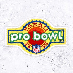 May include: Embroidered patch featuring the words "pro bowl" in green, outlined in white, on a yellow background. The patch includes the text "Hawaii" and "94" with the NFL logo. The patch has a blue border.