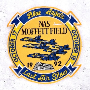 May include: A yellow patch with blue and gold trim featuring the text "Blue Angels NAS Moffett Field" and "Last Air Show". It depicts blue airplanes in formation and the dates "October 17-18, 1992".
