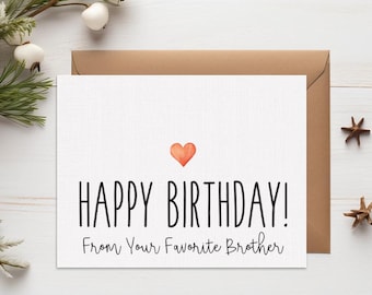 May include: A white birthday card with the text "HAPPY BIRTHDAY! From Your Favorite Brother" and a small orange heart. The card is on a white surface with a brown envelope behind it.
