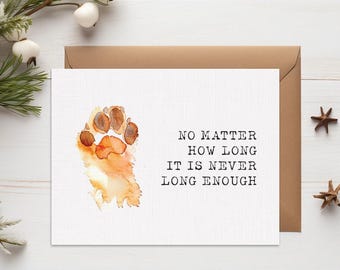 May include: A greeting card with a watercolor paw print in shades of brown and orange. The card has the text "NO MATTER HOW LONG IT IS NEVER LONG ENOUGH" in black. A brown envelope is behind the card.