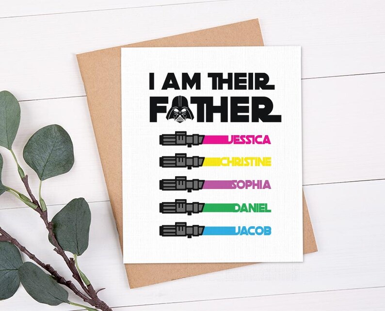 May include: A white greeting card with the text "I AM THEIR FATHER" and a Darth Vader graphic. Below the text are five lightsaber illustrations with names: Jessica, Christine, Sophia, Daniel, and Jacob. The card is on a brown envelope.