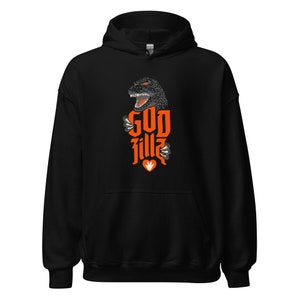 May include: Black hooded sweatshirt with an orange Godzilla graphic and the text "GOD fillz". The design includes a Godzilla head, claws, and a heart. The sweatshirt is made of a soft material.