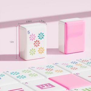 May include: Two white and pink mahjong tiles with floral patterns and the number 5, measuring 1.2 inches in height, 0.86 inches in width, and 0.6 inches in depth, displayed alongside a collection of matching tiles with various numbers and flower designs.