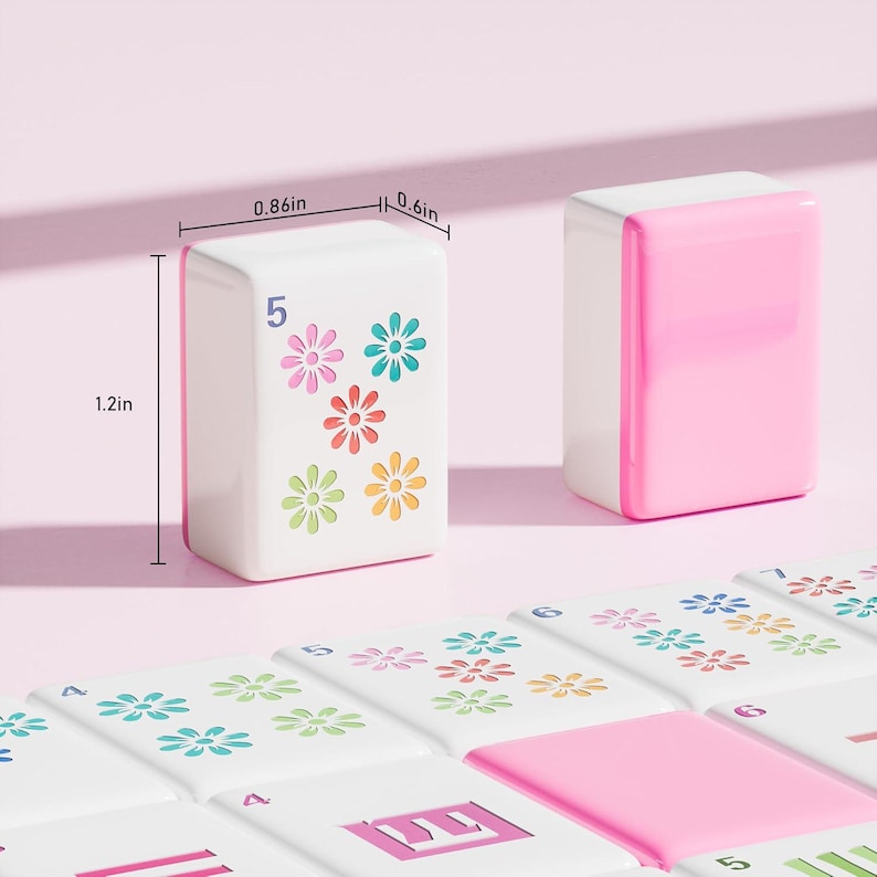 May include: Two white and pink mahjong tiles with floral patterns and the number 5, measuring 1.2 inches in height, 0.86 inches in width, and 0.6 inches in depth, displayed alongside a collection of matching tiles with various numbers and flower designs.