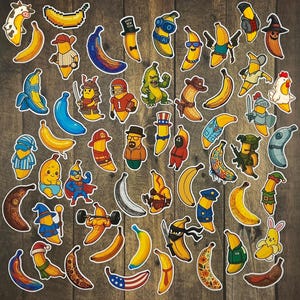 May include: A selection of vibrant banana stickers featuring diverse designs, such as a cow, a pixelated banana, and bananas in costumes like a baseball player, a samurai, and a firefighter. The stickers are displayed on a wooden background.