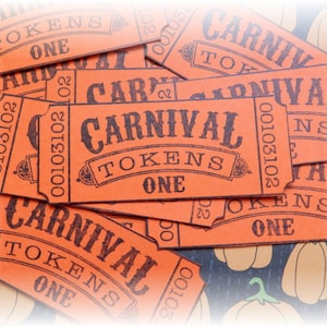 May include: A collection of orange carnival tokens with black text. Each token says "CARNIVAL TOKENS ONE" and has a serial number. The tokens are on a patterned background with pumpkin illustrations.