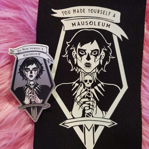 May include: Black and white embroidered patch with a skull and sword design. The patch features the text "You made yourself a mausoleum".
