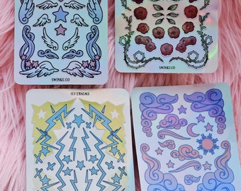 May include: Four holographic sticker sheets with various designs. The first sheet features wings, hearts, and stars. The second sheet features roses, vines, and birds. The third sheet features lightning bolts and stars. The fourth sheet features clouds, stars, moons, and suns. All sheets have the text "SWINKU.CO" printed on them.