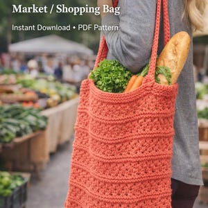 May include: A coral-colored, knitted market bag filled with groceries, including a loaf of bread, carrots, and lettuce. The bag has a textured design and long straps. Text on the image reads "DIGITAL KNIT PATTERN Market / Shopping Bag Instant Download • PDF Pattern."