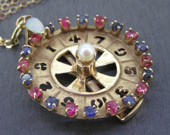 Vintage 14k Gold Spinning Number Wheel Pendant Necklace with Opal, Sapphire, and Ruby