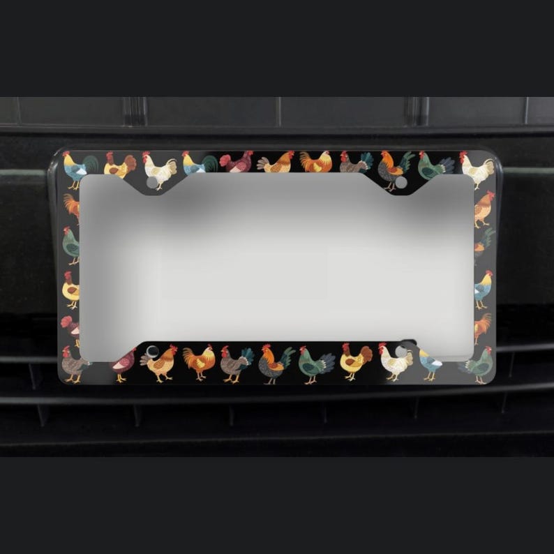 May include: Black license plate frame with a repeating pattern of colorful rooster illustrations. The roosters are in various poses and colors, including red, yellow, blue, and green. The frame has a glossy finish.
