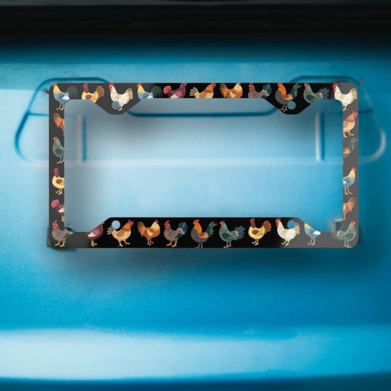 May include: Black license plate frame featuring a repeating pattern of colorful rooster illustrations. The roosters are depicted in various poses and colors, set against a black background. The frame is designed to fit a standard U.S. license plate.