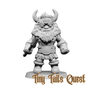 May include: A gray miniature figurine of a horned, muscular warrior holding a spear. The figure has a large beard, fur-lined boots, and a belt with a large buckle. The base of the figurine has the text "Tiny Tails Quest".