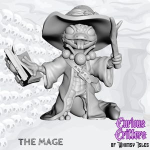 May include: A grayscale 3D-printed figurine of a frog-like mage, wearing a wide-brimmed hat and robe, holding a book and a staff. The figurine has a detailed design, with the text "THE MAGE" at the bottom and "Curious Critters of Whimsy Isles" in the bottom right corner.