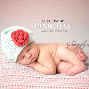 May include: A baby wearing a mint green crochet pixie hat with a red rose, lying on a pink and white striped blanket. The image includes the text "CROCHET PATTERN PIXIE HAT Newborn | Baby | Photo Prop".