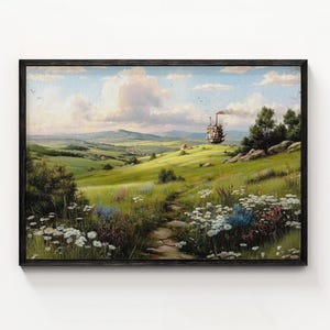 May include: A framed landscape painting depicts a vibrant green meadow with a stone path leading towards a distant hill. A whimsical, moving structure emits smoke. The sky is a mix of blue and white clouds, and the frame is black.