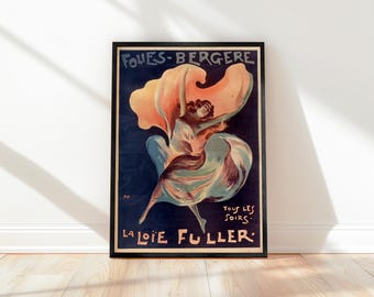 May include: Framed vintage poster featuring a dancer in flowing attire. The poster has a dark blue background with the words "FOLIES-BERGERE" and "LA LOIE FULLER" in white and gold lettering. The dancer is depicted with a large, orange and yellow fabric billowing around her.