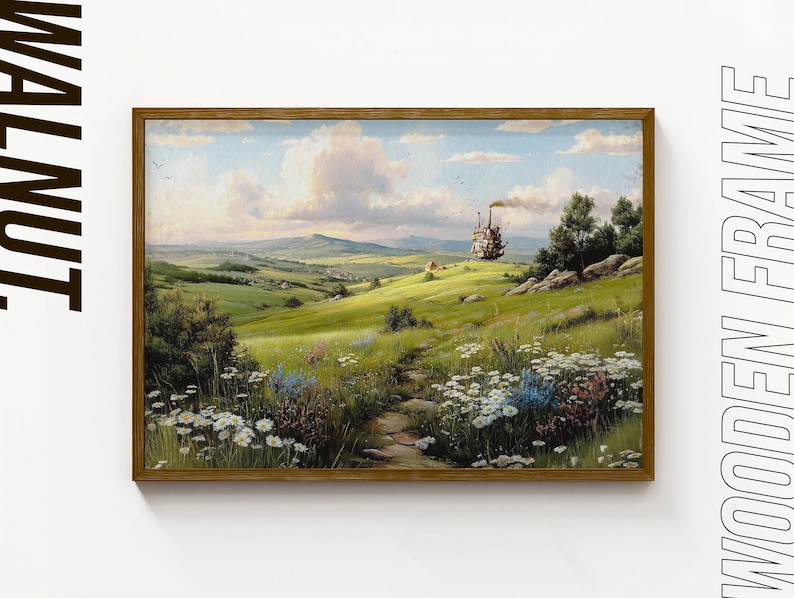 May include: A framed landscape painting with a wooden frame. The artwork depicts a green field with a path leading to a distant hill. A whimsical, moving structure is on the hill. The sky is blue with fluffy clouds.