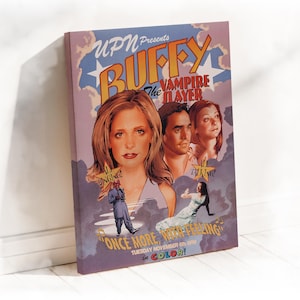 May include: A wrapped canvas print featuring the artwork from the Buffy the Vampire Slayer episode "Once More, With Feeling." The poster-style design includes images of the main characters and the text "UPN Presents Buffy the Vampire Slayer."