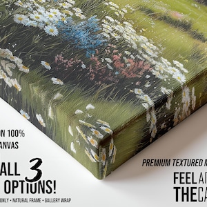 May include: A canvas print featuring a close-up of a meadow scene with white daisies, blue and pink wildflowers, and green grass. The canvas has a textured surface and is printed on 100% cotton canvas.
