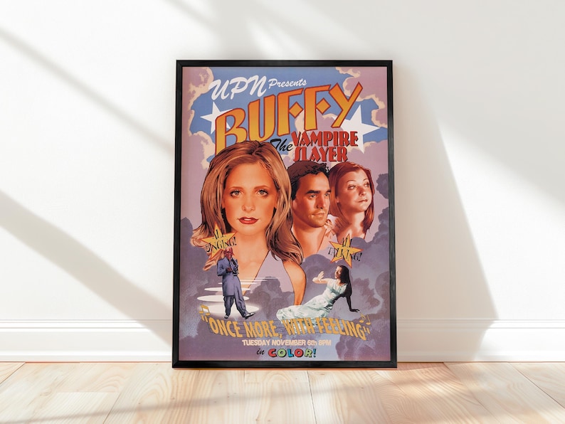 May include: A framed poster for "Buffy the Vampire Slayer" features the show's title in large, stylized letters above images of the main characters. The poster includes the text "Once More, With Feeling" and "In Color!"