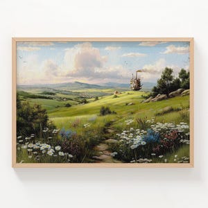 May include: A framed landscape painting with a wooden frame. The artwork depicts a green field with a path leading to a distant mountain range. A whimsical structure with a chimney sits on a hill. The word "NATURAL" is printed on the left side.