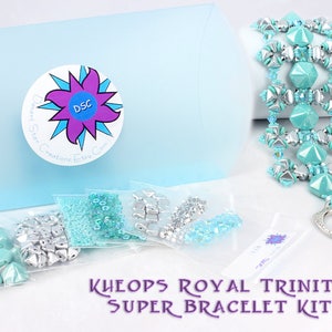 May include: A turquoise and silver bead bracelet kit with the text "KHEOPS ROYAL TRINITY SUPER BRACELET KIT". The kit includes a variety of beads in different shapes and sizes, as well as a clasp and instructions.