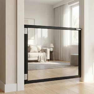 May include: A black framed baby gate with a clear acrylic panel installed in a doorway. The gate is designed to prevent access to a room. The gate is made of metal and acrylic. The gate is installed in a neutral-toned room.