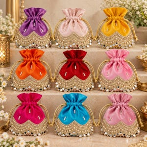 May include: A collection of nine drawstring pouches in various colors including purple, pink, yellow, orange, red, magenta, and blue. Each pouch features a scalloped gold embroidered border with small white pearls and circular mirror accents.